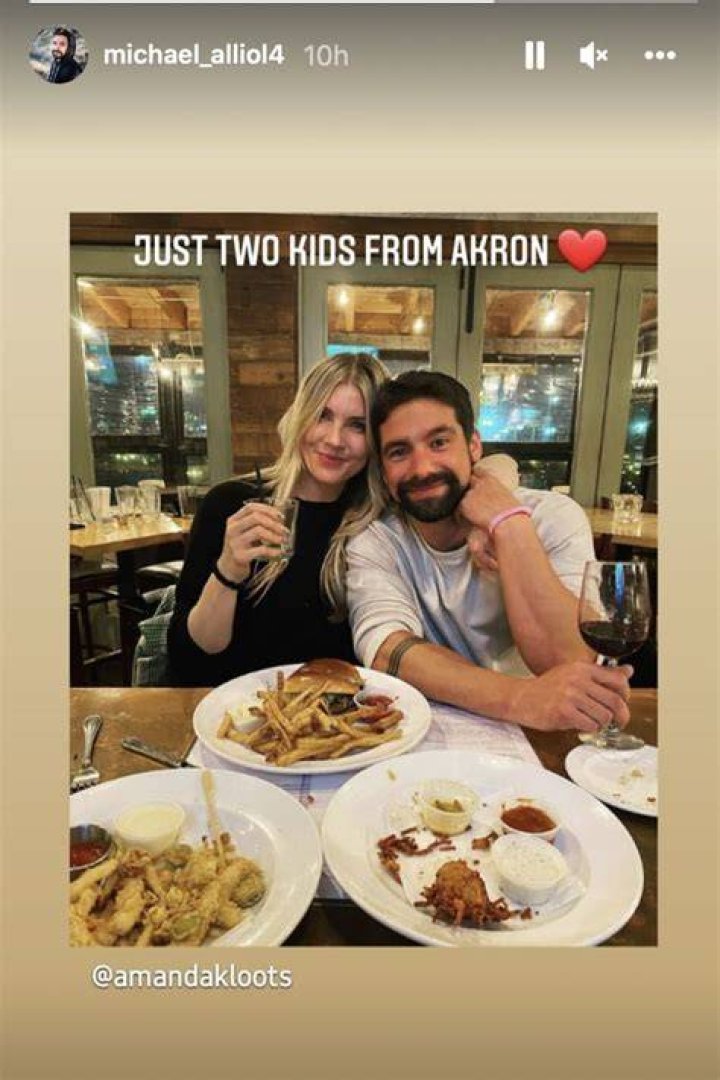 Amanda Kloots and Michael Allio pictured during a dinner while in arms.